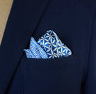 100% silk Moresque Blue Pocket Square in blue by Laslett England. Square is shown arranged in a blue suit pocket to show the central pattern and the smaller geometric pattern of the silk. 