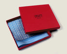 100% silk Moresque Blue Pocket Square in blue by Laslett England. Square is shown packaged in the red signature box. 