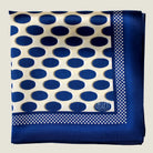 Laslett England Oval Spot Navy pocket square flat lay, showing large oval spot print in navy on cream silk with border detail