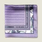 100% silk Panama Lilac pocket square takes its pattern from woven cane and straw, a geometric centre print in soft lilac and white with a botanical border of ferns in complementary tones. Photographed folded into four with the Laslett England logo. 
