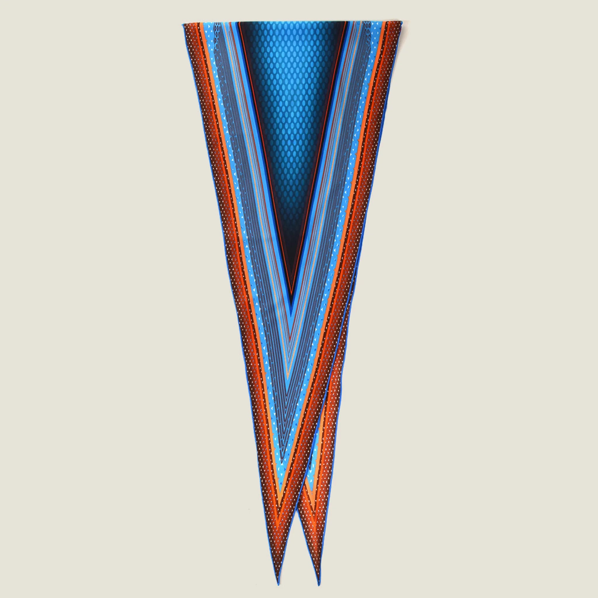 100% silk Sunset Orange Laslett Diamond in orange and blue by Laslett England. Scarf is shown folded over neatly against a neutral background. 