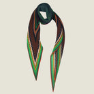 100% silk Riviera Emerald Laslett Diamond in orange; green; geometric by Laslett England. Scarf is shown against a neutral background looped once around the neck. 