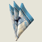 Laslett England Sandpiper Azure silk pocket square folded with pocket points, blue sail plan print on white silk.