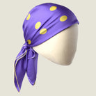 Laslett England Solitaire Violet Foulard knotted as a head covering, violet silk satin with lemon polka dots.