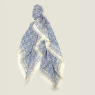 Laslett England Starry Cream Laslett Wrap flat lay, 120cm x 180cm superfine wool in cream ground with blue micro-star print and hand-fringed hem.