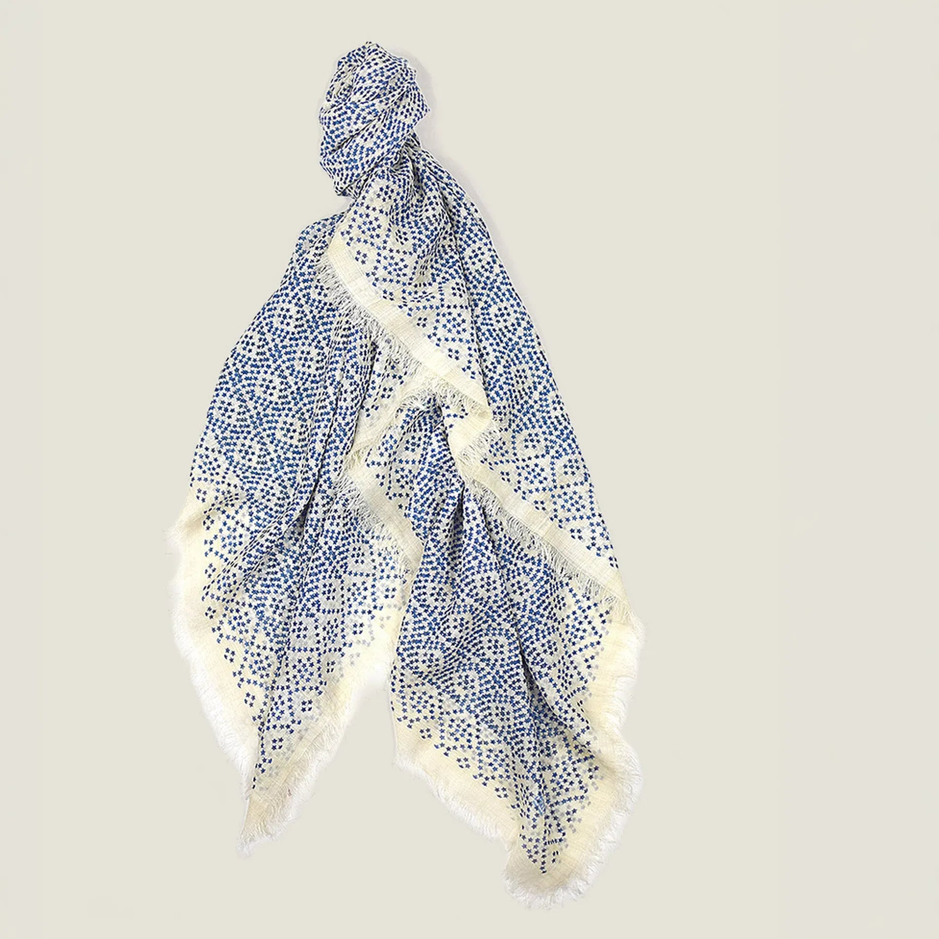 Laslett England Starry Cream Laslett Wrap flat lay, 120cm x 180cm superfine wool in cream ground with blue micro-star print and hand-fringed hem.