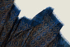 Laslett England Starry Indigo Laslett Wrap detail showing bronze and gold micro-star print on deep indigo superfine wool with hand-fringed hem