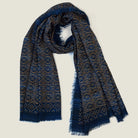 Laslett England Starry Indigo Laslett Wrap flat lay hanging open, showing deep indigo ground with bronze and gold micro-star print and hand-fringed hem