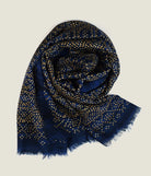 Laslett England Starry Indigo Laslett Wrap folded and gathered, showing deep indigo blue with bronze and gold star print on 100% superfine wool