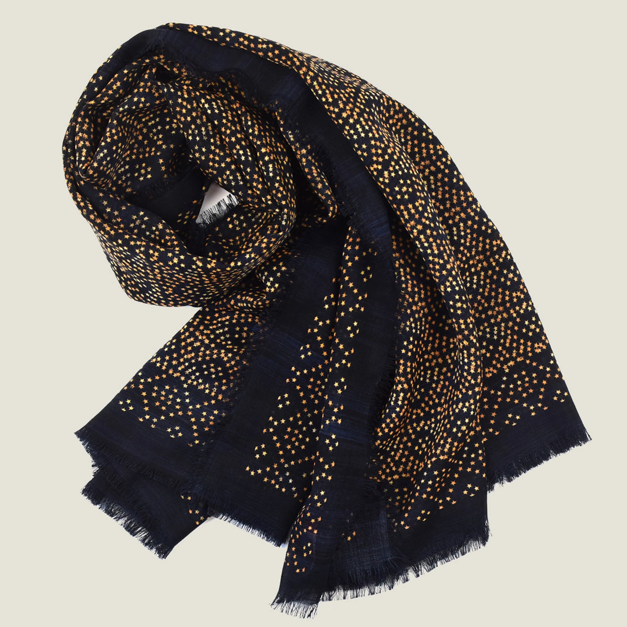 Laslett England Starry Midnight Laslett Wrap folded and gathered, showing blue-black ground with bronze micro-star print on superfine wool
