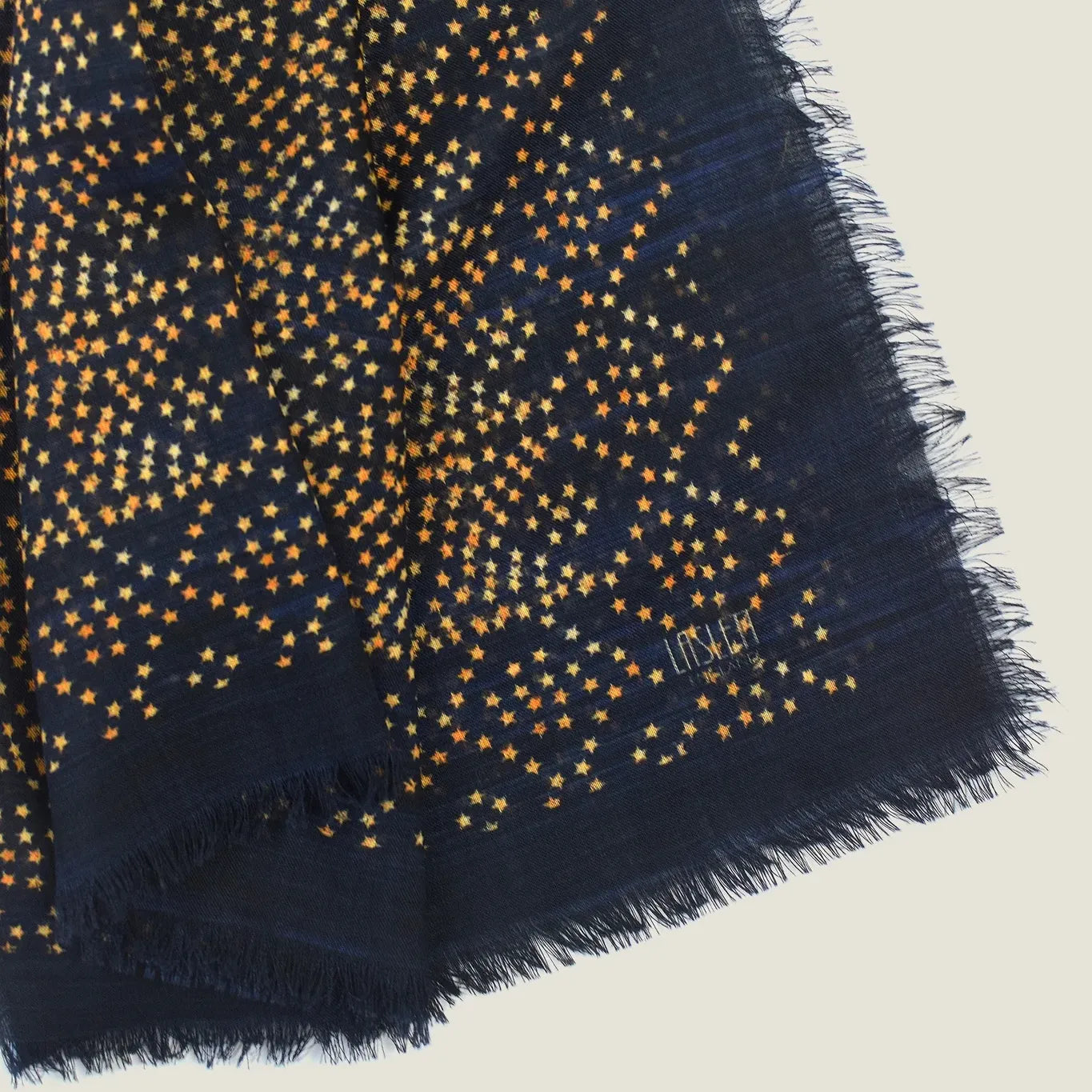 Laslett England Starry Midnight Laslett Wrap detail showing bronze micro-star print on deep blue-black 100% superfine wool ground