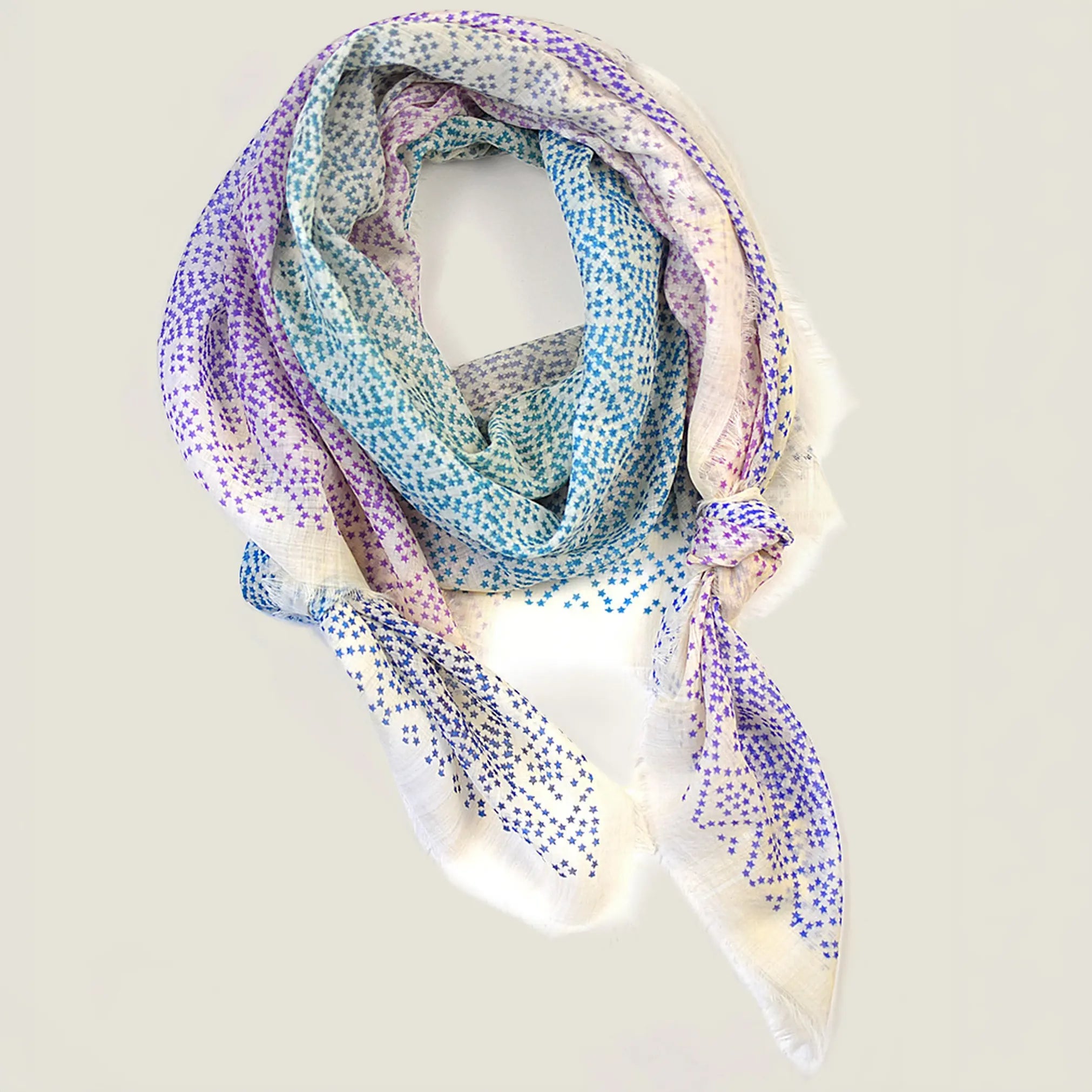 Laslett England Starry Rainbow Laslett Wrap flat lay, 120cm x 180cm superfine wool in gradual rainbow colourway with micro-star print and hand-fringed hem.