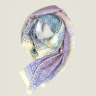 Laslett England Starry Rainbow Laslett Wrap folded flat, showing gradual rainbow transition across micro-star print on superfine wool with hand-fringed hem.