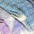 Laslett England Starry Rainbow Laslett Wrap detail showing micro-star print in gradual rainbow colourway on 100% superfine wool.