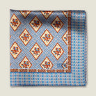 Laslett England Tapestry Rose pocket square flat lay, sky blue and terracotta floral diamond print on silk.