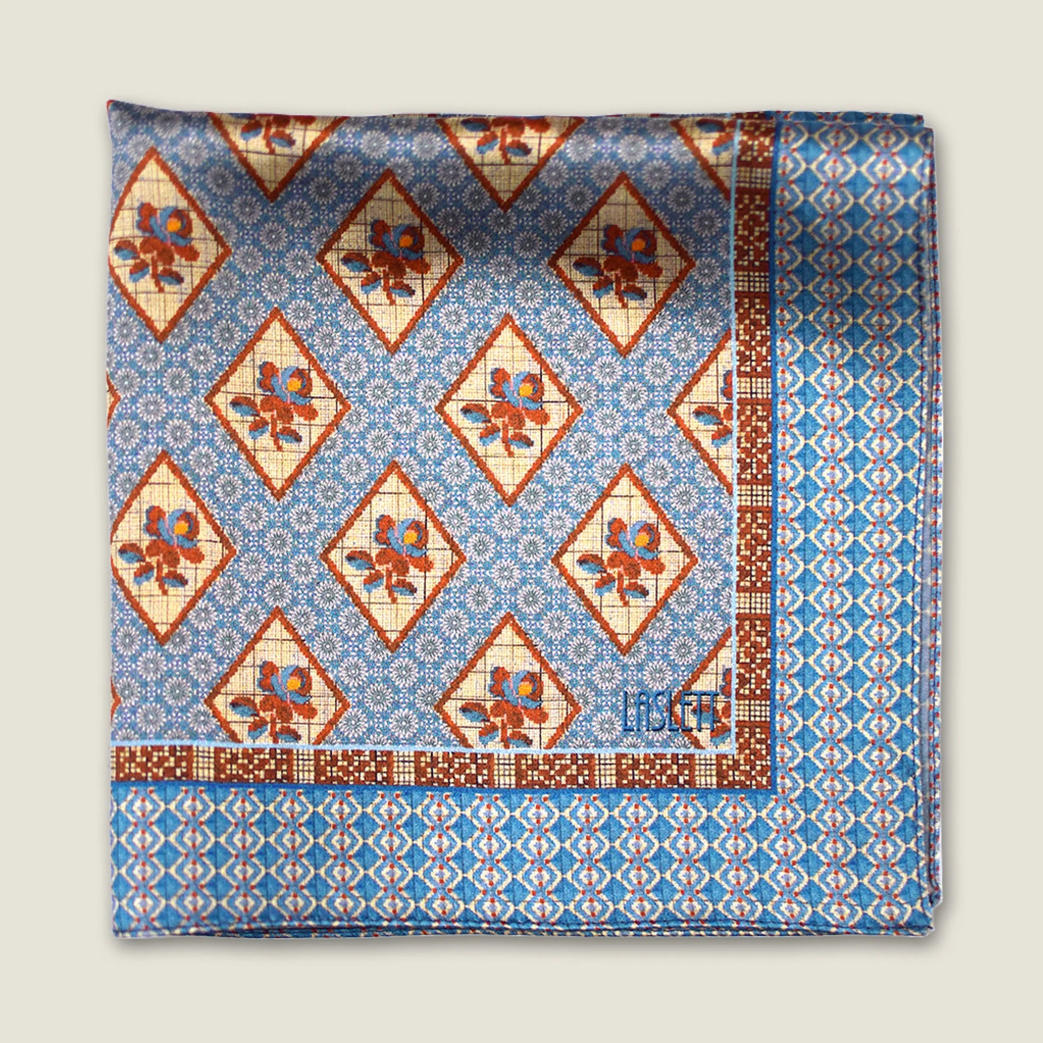 Laslett England Tapestry Rose pocket square flat lay, sky blue and terracotta floral diamond print on silk.