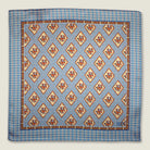 Laslett England Tapestry Rose pocket square folded flat, showing full print repeat in sky blue and terracotta.