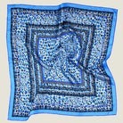 100% silk Tiger Moth Silk Bandana in blue with animal print by Laslett England. Shown in flat lay against a neutral background. 
