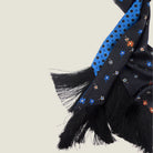 Laslett England Tuxedo Blue Fringed Silk Scarf detail showing black 10cm tassel fringe and cobalt blue silk twill with black geometric dot print.
