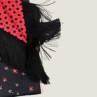 Laslett England Tuxedo Red Fringed Silk Scarf detail showing red ground with black geometric dot print alongside black with red floral pinstripe reverse and 10cm black tassel fringe.