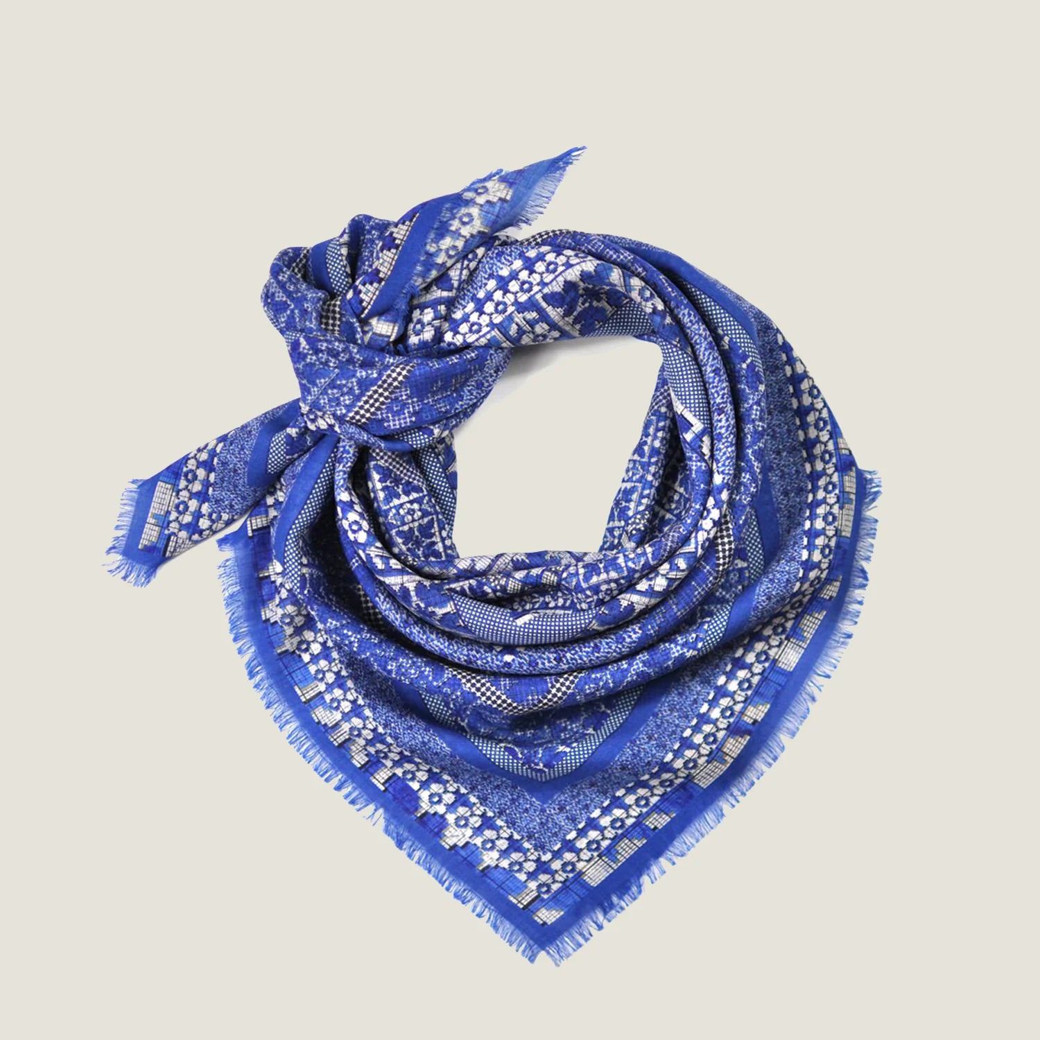 Laslett England Indigo Starry Wrap shown tied behind the neck in flat lay. 