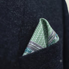 Laslett England Panama Sage pocket square folded into a triangle in a dark sit pocket. 